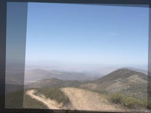 The same three photos averaged after alignment: one sharp hill and road